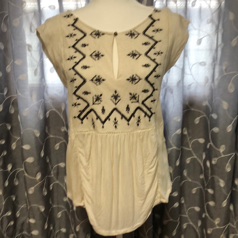 Cream top with black detail.